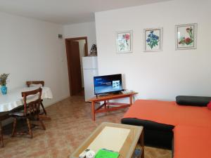 a living room with a couch and a table at Apartma FIGA in Pobegi