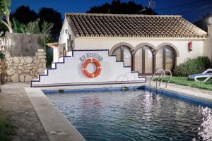 a house with a swimming pool in front of a house at Casas El Suspiro in Zahora