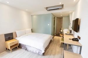 Postel nebo postele na pokoji v ubytování Green Hotel - Chiayi