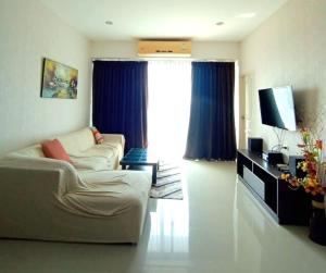 a living room with a couch and a television at Апартаменты с видом на море на Карон Бич А 409 in Karon Beach