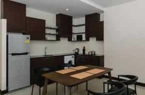 a kitchen with a table and chairs and a refrigerator at Апартаменты с видом на море на Карон Бич А 409 in Karon Beach