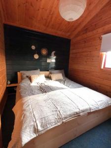 GramsbergenにあるHip Huisje van Houtの木製の壁のベッドルーム1室