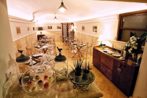 a large room with a table with glasses on it at B&B Al Catillo 1600 - Dimora storica centro Tivoli in Tivoli