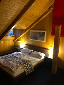 a bed in a room with an attic at Happy Village Kastiel Ivachnova in Ivachnová