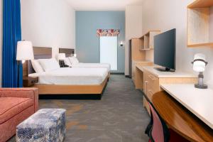 a hotel room with a bed and a television at Home2 Suites by Hilton Buffalo Airport/ Galleria Mall in Cheektowaga +23 photos