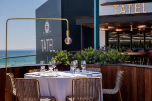 a table with wine glasses on top of a restaurant at Hard Rock Hotel Ibiza in Playa d'en Bossa