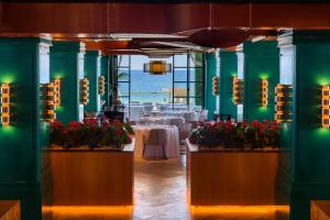 a dining room with tables and flowers in a room at Hard Rock Hotel Ibiza in Playa d'en Bossa