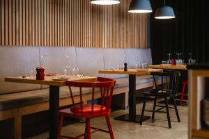 a restaurant with two tables and two stools at DoubleTree by Hilton Malta in St Paul's Bay