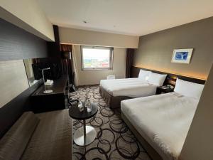 Un pat sau paturi într-o cameră la ANA Crowne Plaza Hotel Kushiro by IHG