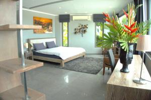 a bedroom with a bed and a plant in a room at Phuket 4-Bedrooms Seaview Private Villa 1224m2 XXL Luxury Infinity Pool in Ban Pa Khlok +109 photos