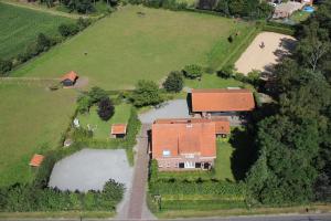 an aerial view of a house with a pond at B&B Maarle in Poppel