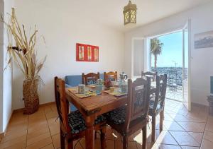 a dining room with a wooden table and chairs at Solemar Sicilia - Casa Aura in Porticello
