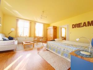 a bedroom with a bed and a living room at Ferienwohnung "Altes Pastorat" in Welt