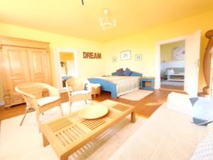 a bedroom with a bed and a living room at Ferienwohnung "Altes Pastorat" in Welt +21 photos