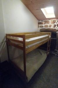 a wooden bunk bed in a room with a window at Casa da Padeira in Trancoso