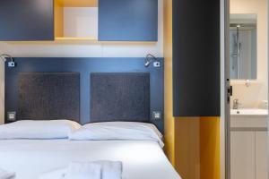 Cama ou camas em um quarto em Villaggio Miramare