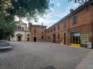 an empty cobblestone street in an old town at Il Carro Rooms - Monza Centro, Tribunale, Ospedale in Monza