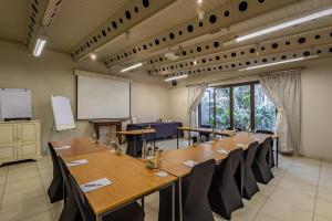 a conference room with a long table and chairs at Singa Lodge - Lion Roars Hotels & Lodges in Port Elizabeth +37 photos