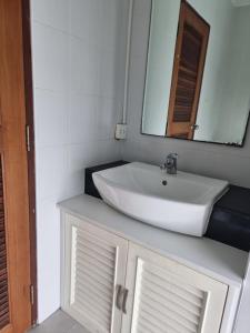 a bathroom with a white sink and a mirror at Néo Condo Jomtien Pattaya in Jomtien Beach +9 photos