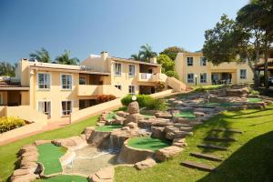 a house with a golf course in the yard at Chakas Rock Chalets - Unit 19 in Ballito
