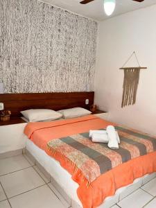 a bedroom with a bed with two pillows on it at Bella vida Geriba suites in Búzios +31 photos