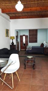 a living room with a couch and a table at Camdeboo Cottages in Graaff-Reinet