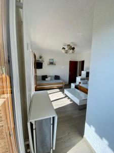 a living room with a table and a couch at Charmant logement 4 personnes in Lans-en-Vercors +11 photos