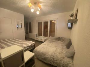 a bedroom with two beds and a television in it at Charmant logement 4 personnes in Lans-en-Vercors