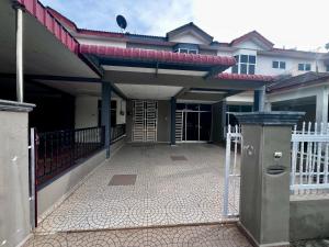 a house with a porch with a fence and a gate at DH Homestay in Sungai Petani