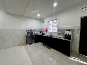 a kitchen with a sink and a counter top at DH Homestay in Sungai Petani