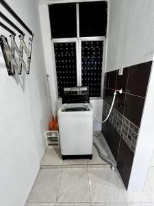 a small kitchen with a sink and a window at DH Homestay in Sungai Petani