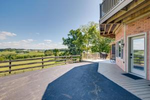 an open door to a house with a fence at 4 Mi to German Village Studio with Hot Tub! in Millersburg