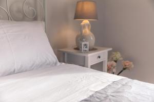 A bed or beds in a room at Marinella Suite Home