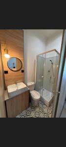 a bathroom with a toilet and a sink and a shower at METRO Pokoje & Parking in Sopot