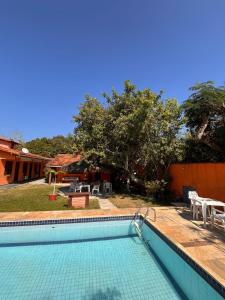 a swimming pool in front of a house at Bella vida Geriba suites in Búzios