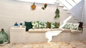 a couch sitting on a wall with pillows on it at Paradise Sea Terrace in Monopoli