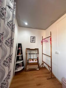a room with a crib and a shelf in it at Heaven Guesthouse in Pakse +161 photos