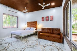 a bedroom with a bed and a couch at Coco Bliss By Mauli Stays in Manor +31 photos