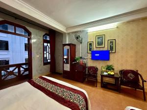 a bedroom with a bed and a tv on the wall at Hà Giang Hotel Sapa in Sa Pa +36 photos