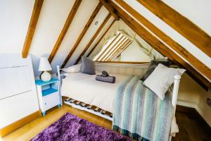 a bedroom with a bed in the attic at Seaglass Little Haven in Little Haven