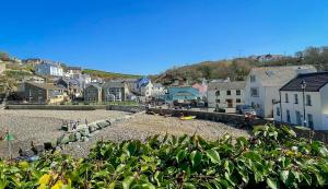 a small town with houses and a rocky beach at Seaglass Little Haven in Little Haven