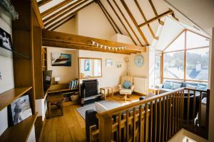 a living room with a staircase and a living room with at Seaglass Little Haven in Little Haven