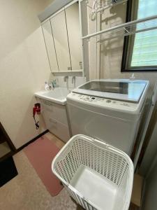 a small kitchen with a stove and a sink at Grace House グレイスハウス- Country Home Relaxation in Okawa +24 photos