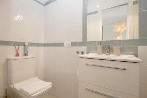 ein weißes Badezimmer mit Toilette und Waschbecken in der Unterkunft Estepona Centre Fishermans Cottage LEIF in Estepona + 16 Fotos