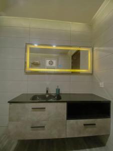 a bathroom with a sink and a mirror at 01 BHK CONDO IN FRONT OF CENTORUs in Islamabad