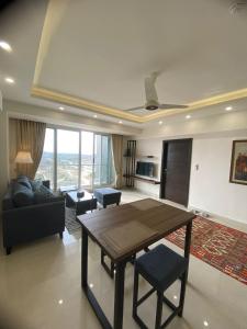 a living room with a table and a couch at 01 BHK CONDO IN FRONT OF CENTORUs in Islamabad