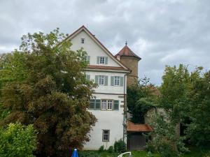 a large white house with a tower on top of it at Gemminger Gasthaus in Gemmingen