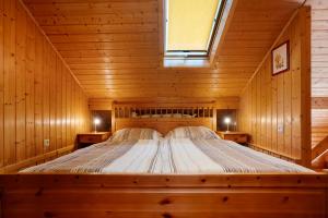 a bedroom with a bed in a wooden room at Ferienhaus Moritzburg in Moritzburg
