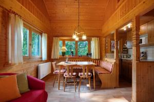 a kitchen and dining room with a table and chairs at Ferienhaus Moritzburg in Moritzburg