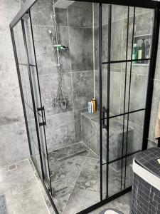 a shower with a glass door in a bathroom at Villa with private pool and sea view in Dikili